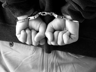 Handcuffed hands behind someone's back